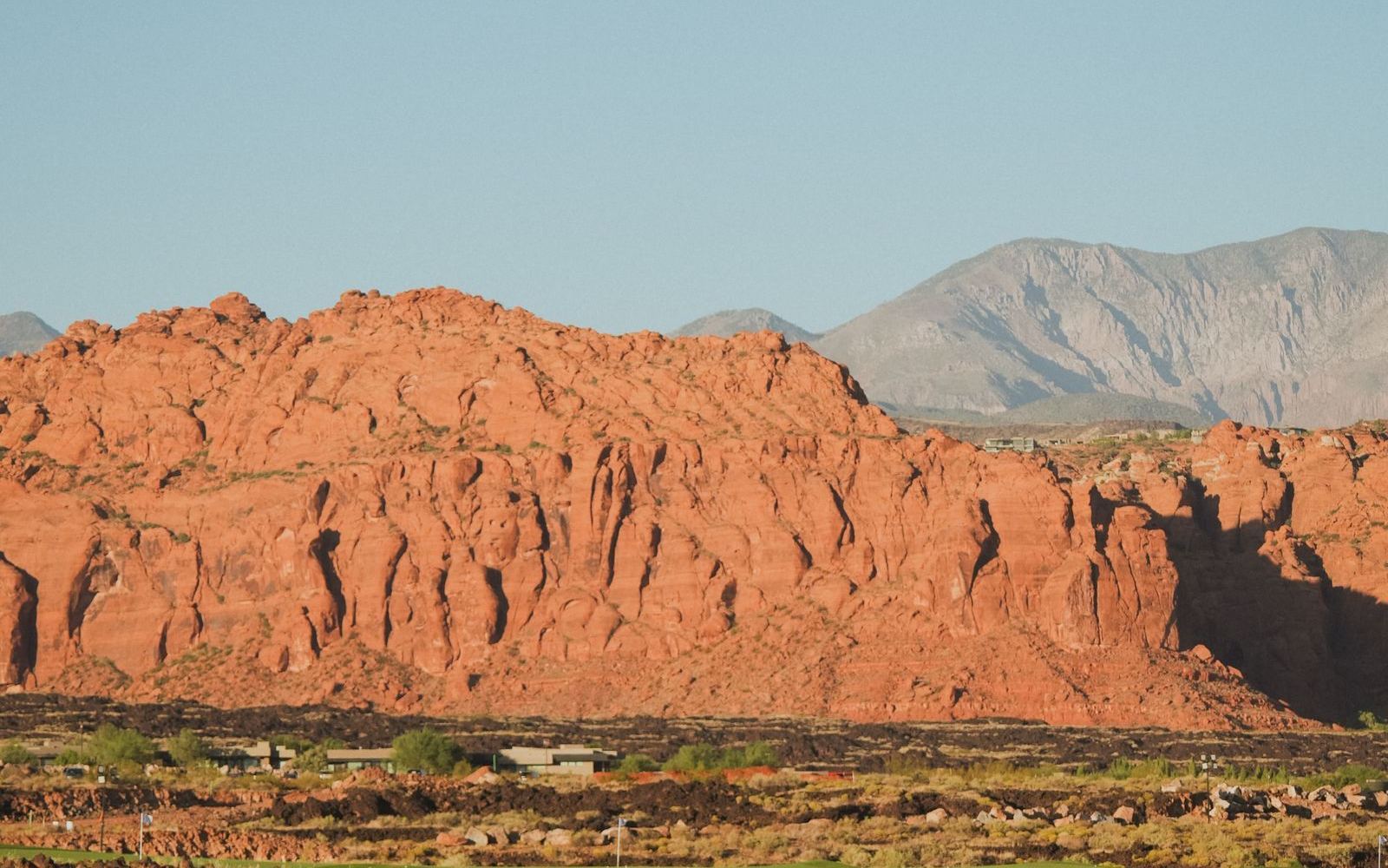 A desert golf course fairway with mountains behind