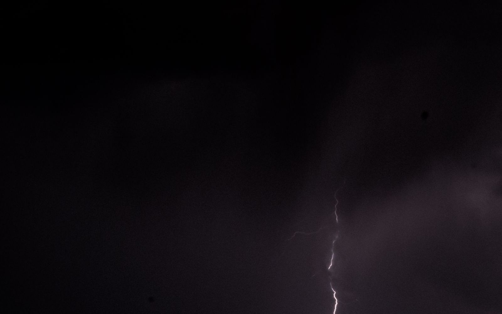 Dramatic monsoon storm clouds and lightning over the desert